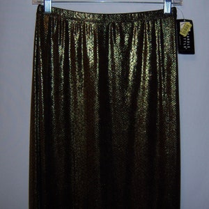 May include: A long black skirt with a gold snakeskin pattern. The skirt is made of a shiny fabric and has a high waist.
