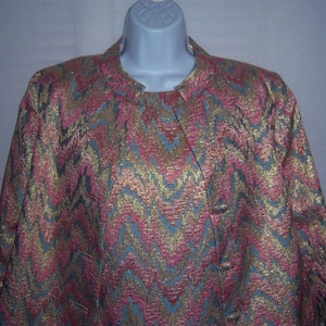 May include: A gold, pink, and blue patterned blazer with a mandarin collar and button closure.