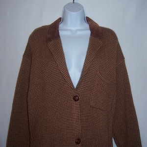 May include: A brown and tan checkered blazer with a brown suede collar and button closure.