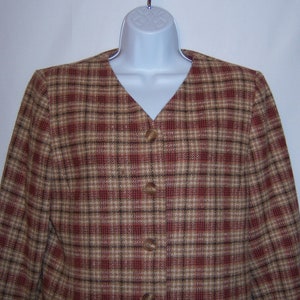 May include: A brown, red and black plaid blazer with a v-neck and button fastening.