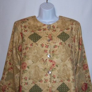 May include: A long-sleeved, button-up blouse with a patchwork design featuring a floral pattern in shades of brown, green, and red.