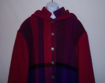 May include: A hooded jacket with a plaid pattern in shades of red, purple, and black. The jacket has a button closure and silver buttons.