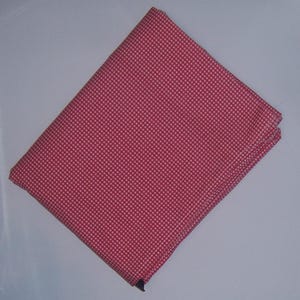 May include: A pink and white gingham fabric with a small checkered pattern.