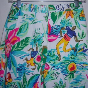 May include: White shorts with a colourful tropical print featuring stylised figures, flowers, and leaves.