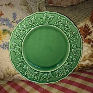 May include: A green ceramic plate with a raised design of chickens and corn stalks around the rim.