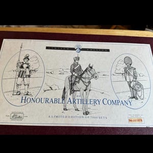 May include: A limited edition print featuring illustrations of soldiers and a mounted officer, with the text "Honourable Artillery Company." The print is numbered 001578 and is set within a dark red frame.