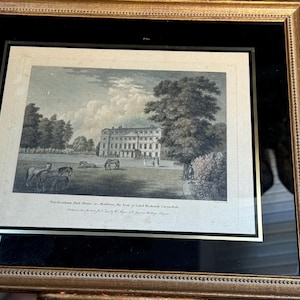 May include: A framed antique print of a large house with a grassy lawn and trees. The print is titled "The Sudbrook Park House, in Wiltshire, the Seat of Lord Bolingbroke, Engraved by J.P. Malchair, from a Drawing by J.B. Malchair, Published by J.B. Malchair, London, 1810."