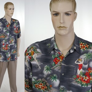 May include: A gray short-sleeved button-down shirt with a tropical print featuring palm trees, flowers, and women in swimsuits.