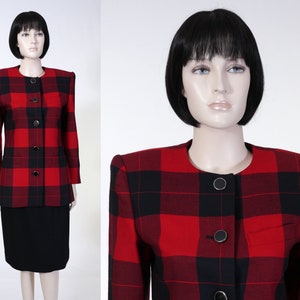May include: A red and black plaid blazer with a round neckline and button closure. The blazer has a fitted silhouette and is made of a soft, textured fabric.
