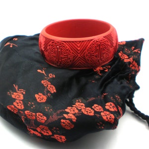 Cinnabar Carved Bangle in Satin Bag