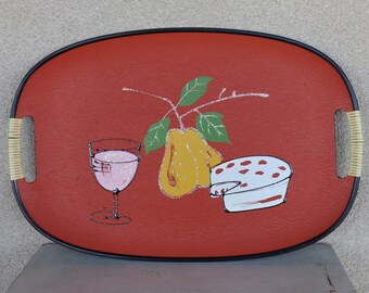 May include: A red oval serving tray with black trim and bamboo handles. The tray features a hand-painted design of a glass of pink wine, a yellow pear, and a white wedge of cheese with red dots.