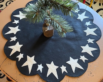 Star tree skirt measuring12 - 24 inches across with a black background and off white stars. Coffee dye stars available upon request.