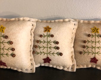 Set of 3 feather tree bowl filler pillows shown in coffee dye background measuring 5 inches across.