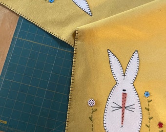 Primitive bunny. table runner mellow yellow background with button flowers and off white bunny.