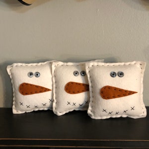 Snowman bowl filler pillows set of 3 measuring 5 inches square.