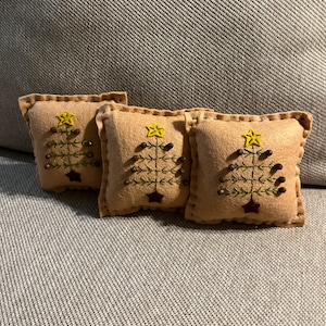 Set of 3 feather tree bowl filler pillows shown in tan background measuring 5 inches across.