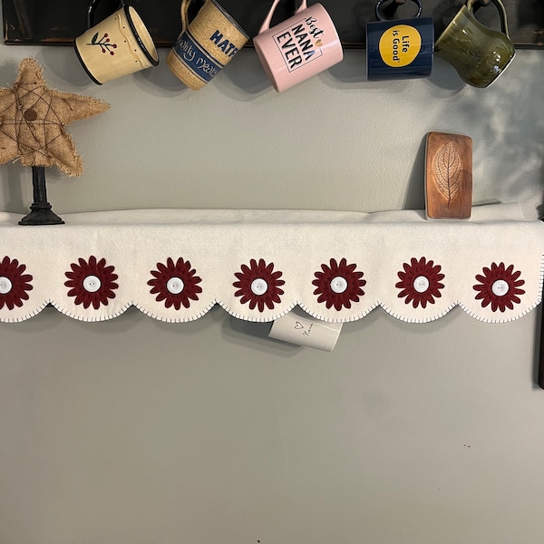 Mantle /shelf scarf with flowers in each of the scallops with an off white background measuring 14x36”.