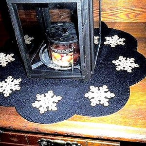 Primitive snowflake candle mat with coffee dye snowflakes(shown) or off white snowflakes on a black background. image 1