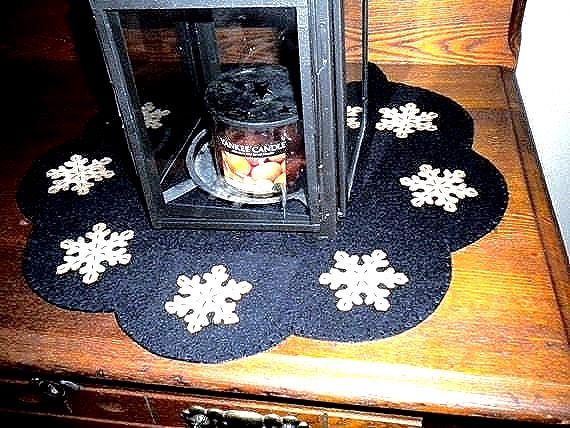 Primitive snowflake candle mat with coffee dye snowflakes(shown) or off white snowflakes on a black background.