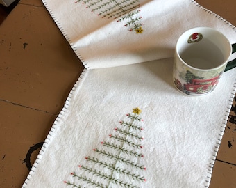 Primitive feather tree table runner with an off white background