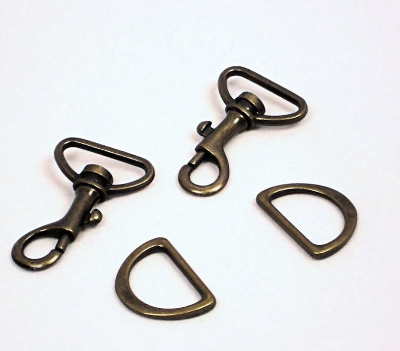 May include: Three antique gold-toned metal clasps, two are swivel clasps and one is a D-ring.