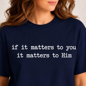 May include: A dark navy blue short-sleeved t-shirt featuring white text printed on the chest that reads, if it matters to you it matters to Him. The shirt has a classic crew neckline and a simple, clean design with no other visible patterns.