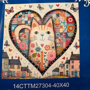 May include: A cross-stitch kit with a colourful design. The image shows a heart-shaped design with a cat, flowers, and butterflies. The kit includes Aida fabric, needles, and instructions. The text reads "14 count".