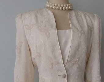 Nicole Miller Creme Color Suit with pearl embellishments and button. From the Dyynasty collection size 4/6. Perfect for mother of the bride.