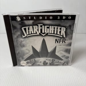 May include: A black and white CD case for the video game Starfighter. The case has the game title in large, bold letters with a futuristic spaceship design. The text "NFR" and "NOT FOR RESALE" are also visible.