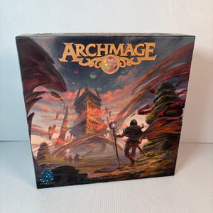 May include: A board game box titled "Archmage" features a fantasy landscape with a figure holding a staff. The box art showcases a castle, a figure with a staff, and the Starling Games logo. The color palette includes shades of red, orange, and blue.
