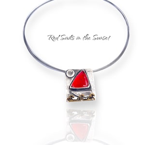 May include: A silver necklace with a red sail pendant. The pendant is made of silver and has a red glass sail with a gold trim. The pendant is attached to a silver chain. The necklace is called "Red Sails in the Sunset".