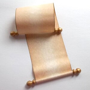 May include: A blank scroll made of light tan, textured paper. The scroll features two wooden rods at the top and bottom, each finished with rounded, gold-colored decorative finials on both ends. The paper is partially rolled at the top.