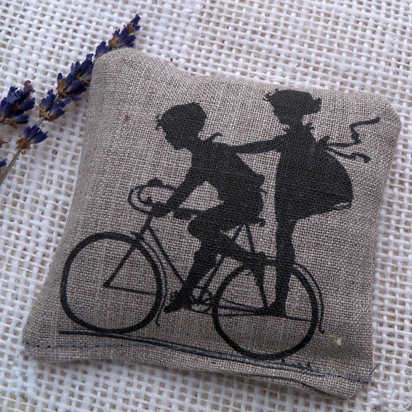 Lavender sachet on rustic linen fabric vintage children on a bike illustration