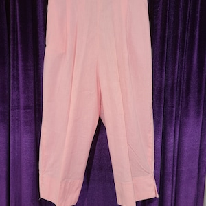 May include: A pair of light pink cropped pants with a high waist and a straight leg.
