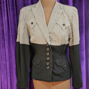 May include: A black and white gingham blazer with a black bottom half. The blazer has a fitted waist and features a button closure and pockets.