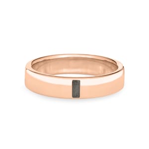 May include: A rose gold band ring with a thin black rectangular inlay.