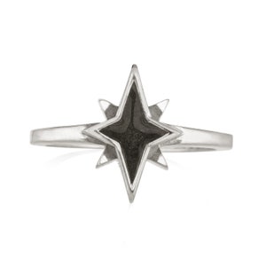 May include: A silver ring with a black star-shaped stone in the center. The star has eight points and is set in a silver band.