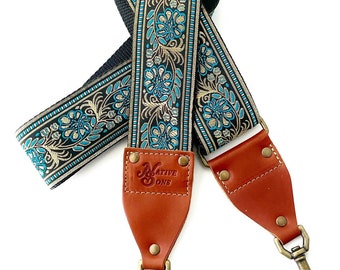 The Luna Guitar Strap Style Bag Strap - Blue and Gold Floral on a Black Background with black Nylon or Natural Hemp made with Leather