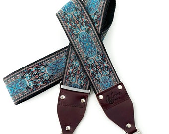 The Calypso Guitar Strap Style Bag Strap - Blue Gold and Burgundy Tapestry Style strap on a Black Background with Nylon or Hemp and Leather