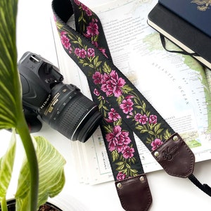 The Odel Camera Strap Fuchsia Pink and green floral on a black background, & leather image 1