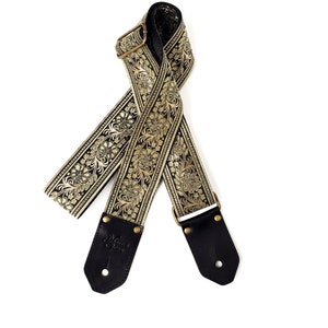 Eclipse Gitarrengurt von Native Sons - Goldenes und schwarzes Blumenmotiv Gitarrengurt aus Leder und Nylon oder Hanf