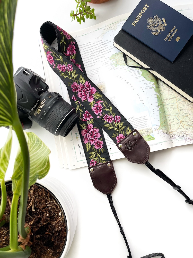 The Odel Camera Strap Fuchsia Pink and green floral on a black background, & leather image 1