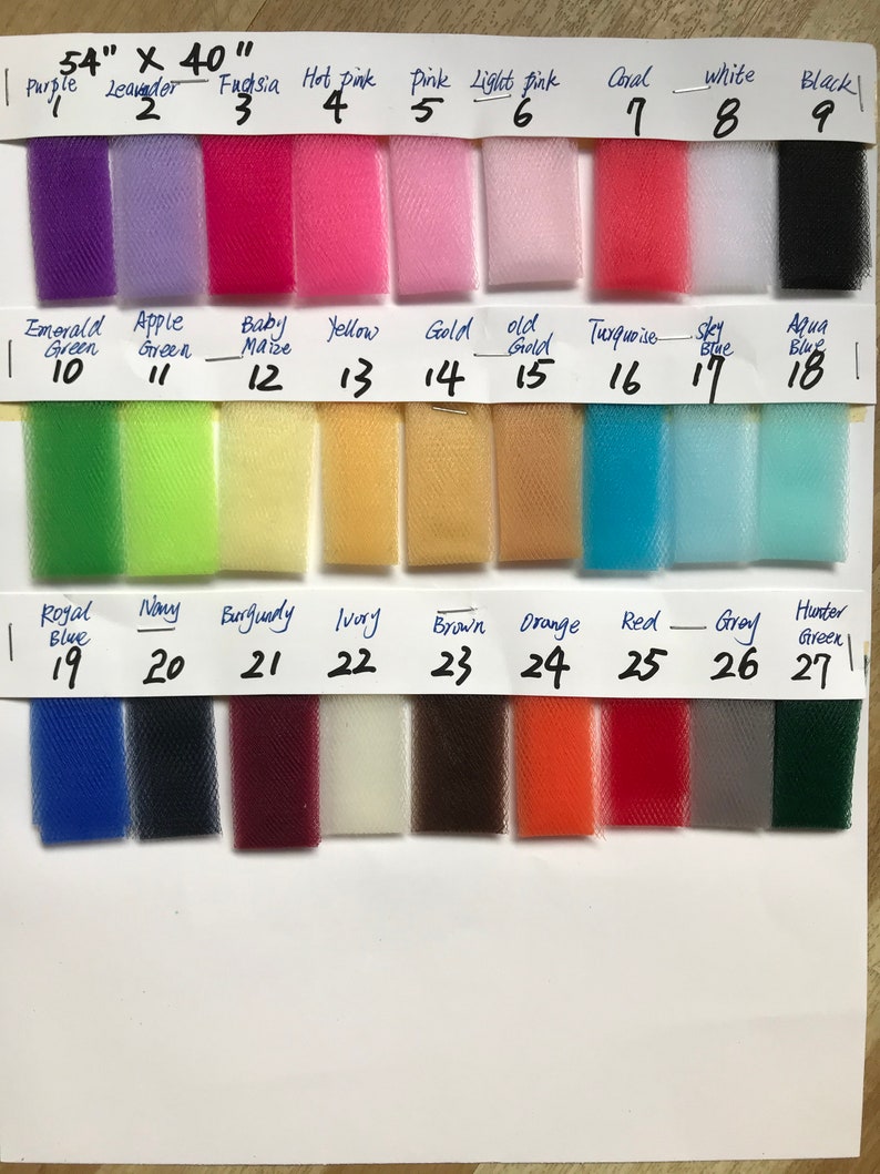 May include: A color chart of 54" x 40" tulle fabric swatches. The swatches are arranged in rows and columns, with each swatch labeled with a number and a color name. The colors include purple, lavender, fuchsia, hot pink, pink, light pink, coral, white, black, emerald green, apple green, baby maize, yellow, gold, old gold, turquoise, sky blue, aqua blue, royal blue, navy, burgundy, ivory, brown, orange, red, gray, and hunter green.