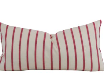May include: A rectangular decorative pillow with a cream-colored background and vertical stripes in a vibrant red hue. The pillow's design features a classic striped pattern, adding a touch of elegance to any room. The pillow is approximately 20 inches long.