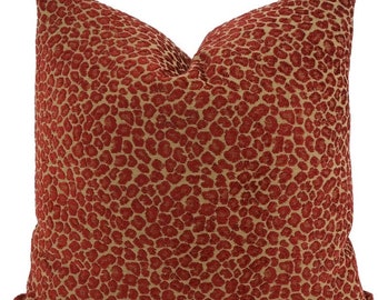 May include: A red and tan throw pillow with a leopard print pattern.