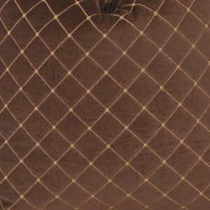 May include: A brown velvet pillow with a diamond pattern stitched in gold thread.