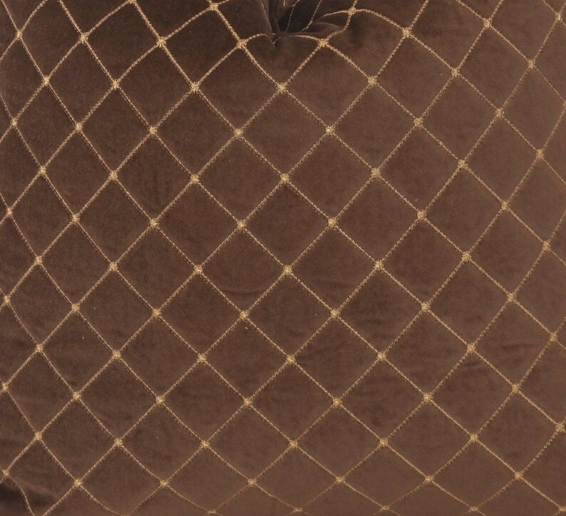 May include: A brown velvet pillow with a diamond pattern stitched in gold thread.