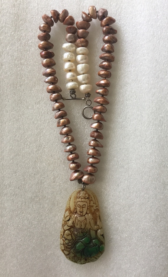 Long brown bronze colored necklace with beaded pendant.