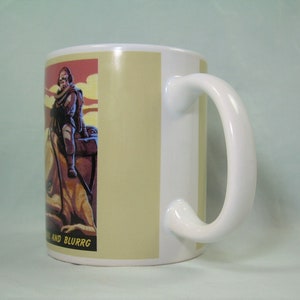 Puede incluir: Taza de cer&aacute;mica blanca con asa. La taza tiene una imagen colorida de una persona montando una criatura con el texto "and BLURRG" en la parte inferior.