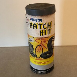 May include: A vintage Victor Patch Kit for all rubber repairs. The yellow and black label features a bicycle, boots, and tires. The label reads "Victor Patch Kit" and "For All Rubber Repairs".